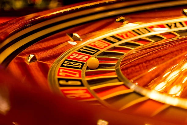 Close-up of live roulette wheel with betting layout and real-time chat interface